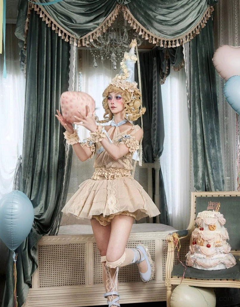 Layered lace tulle mini skirt worn in a playful lolita party costume with ornate headdress, beige ruffles, and statement styling