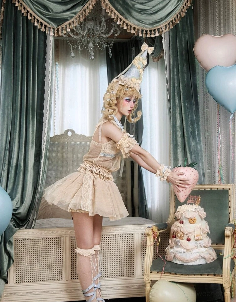 Side three-quarter view of a layered lace tulle mini skirt styled with lace leg wraps and vintage lolita accessories