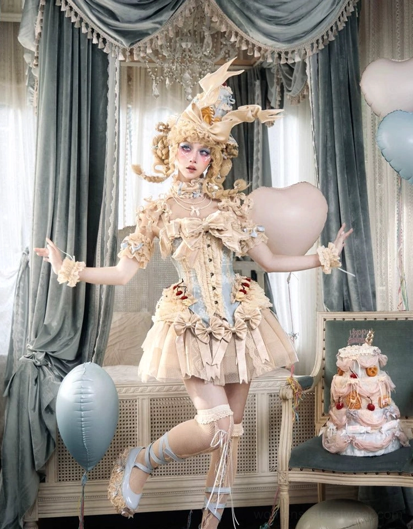 Layered lace tulle mini skirt worn in a stage-ready lolita performance outfit with blue accents, ornate headdress, and romantic styling