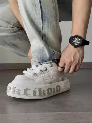 White chunky platform skate sneakers styled on foot with light wash jeans for casual streetwear outfit inspiration