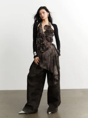 Full-body model wearing a dark gray layered ruffle halter top set with black bolero, camouflage wide-leg trousers, and silver pointed shoes