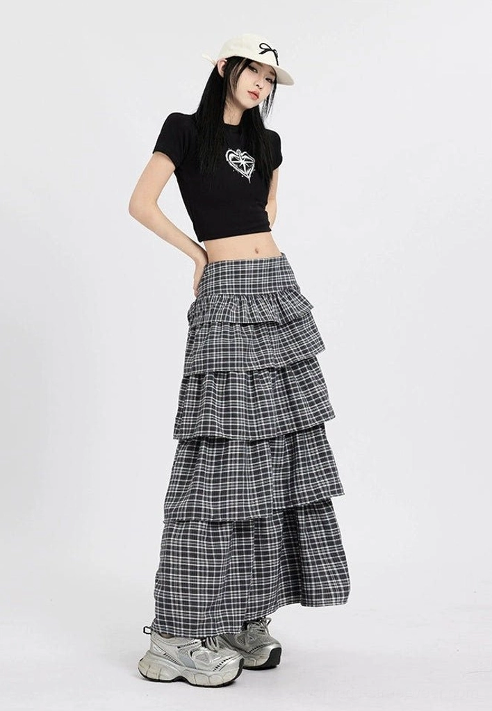 Side three quarter view of a layered ruffle plaid maxi skirt with high waist and relaxed flowing streetwear fit