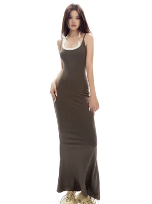 Dark brown layered two-tone bodycon maxi tank dress with contrasting white halter neckline and fishtail hem styled with beige chunky sneakers