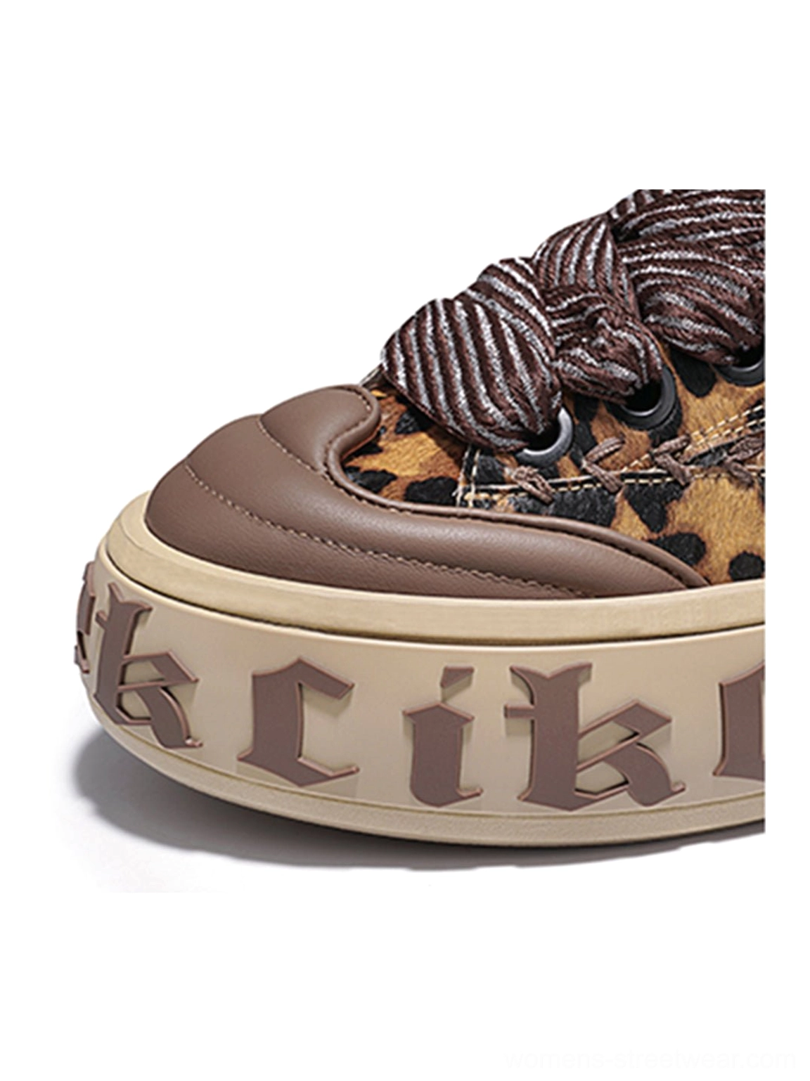 Close-up of leopard chunky skate sneaker toe with brown cap, oversized braided laces, and layered streetwear construction