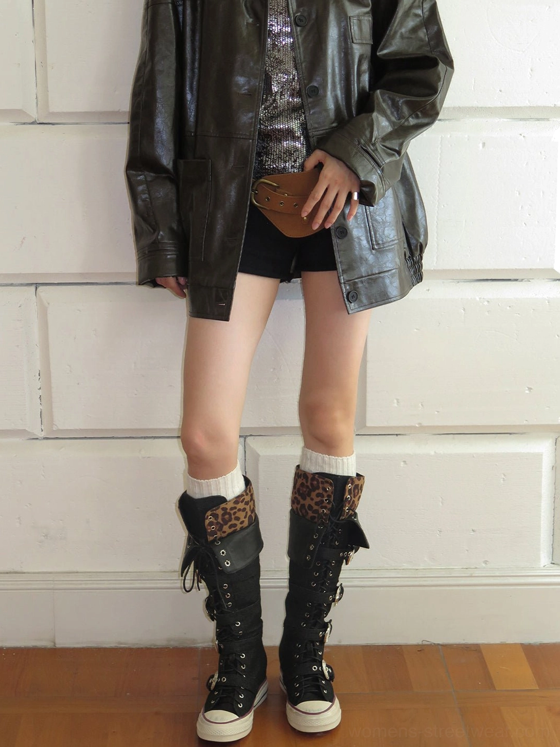 Back view of leopard cuff buckle knee-high canvas streetwear boots worn with black shorts and white socks