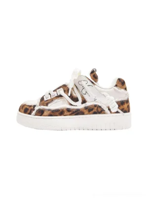 Leopard deconstructed platform canvas sneakers shown in a standalone side-front product view with frayed white fabric panels, layered canvas overlays, embroidered vamp details, and a thick white rubber outsole