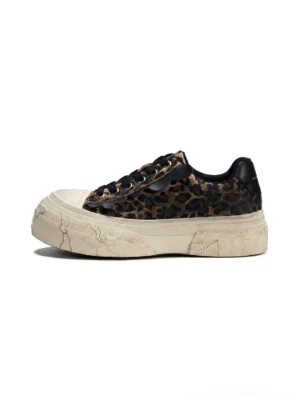 Side profile of leopard distressed platform canvas sneakers with black laces, black heel accent and cracked off-white vintage sole