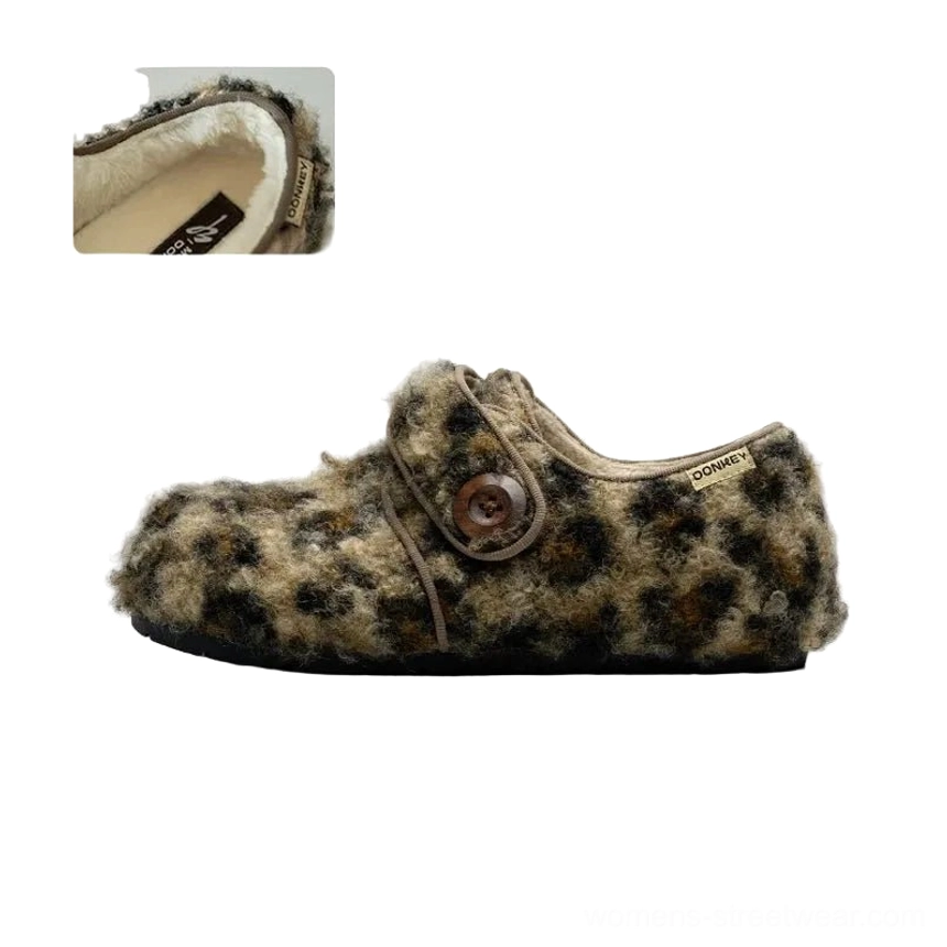 Side view of leopard pattern fleece Mary Jane slippers with soft plush upper, round button fastener, closed toe, and textured heel detail