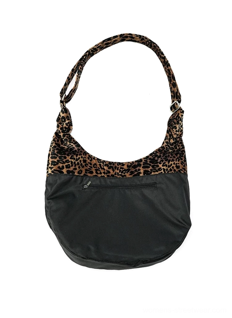 Leopard panel hobo shoulder bag showing hidden front zipper pocket black base and adjustable leopard strap