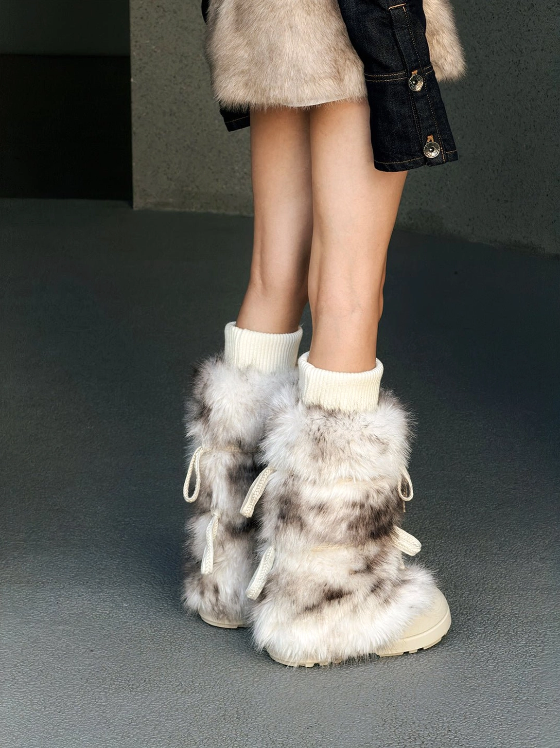 Back view of leopard print fuzzy platform boots with lace-up accents, ribbed cuffs, and chunky white soles