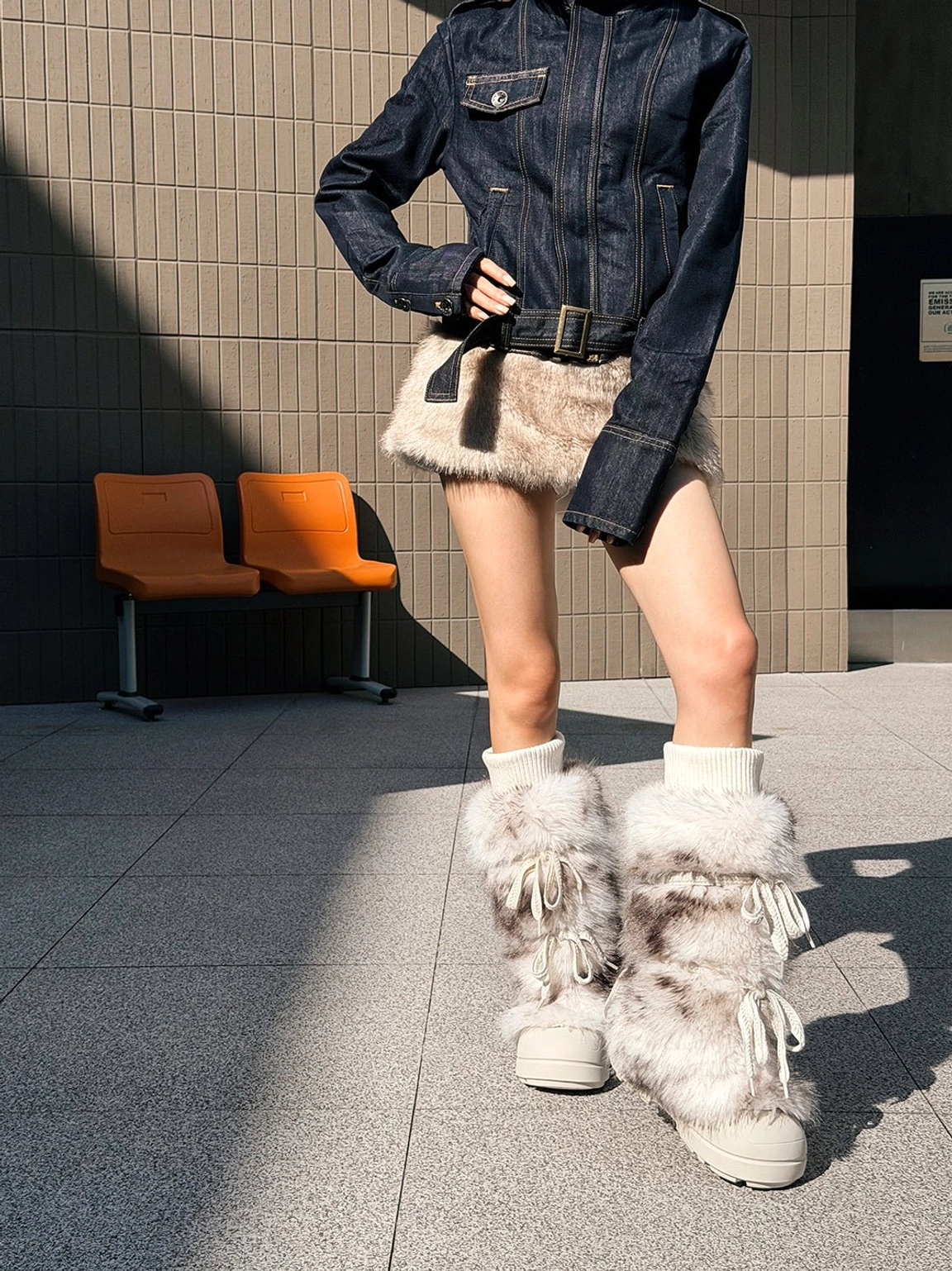 Full outfit styling with leopard print fuzzy platform boots, denim layers, and plush mini skirt