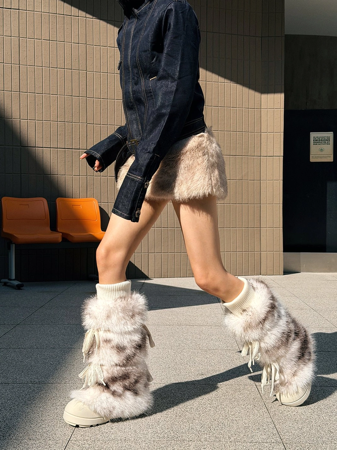Side view of leopard print fuzzy platform boots featuring lace-up details and thick off-white platform soles