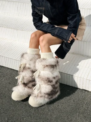 Model wearing leopard print fuzzy platform boots with plush sock cuffs and thick off-white soles from above