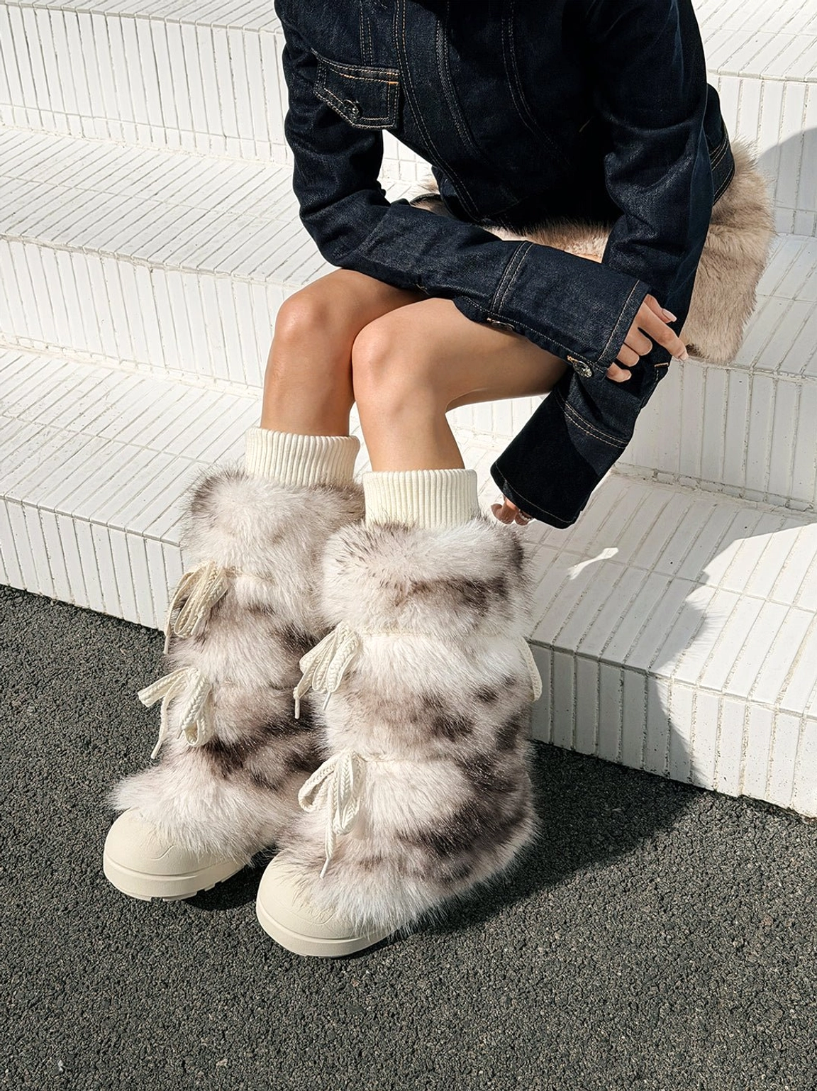 Model wearing leopard print fuzzy platform boots with plush sock cuffs and thick off-white soles from above