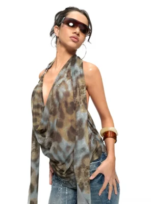 Three-quarter view of a muted brown grey leopard print halter top with fluid cowl draping, deep neckline, and relaxed Y2K streetwear silhouette