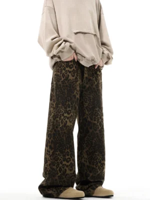 Leopard print high-waist wide-leg streetwear trousers front three-quarter view styled with an oversized beige hoodie