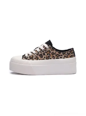 Side profile of leopard print platform canvas sneakers for women with a thick white rubber sole, black toe cap, low-top lace-up design, and bold streetwear styling