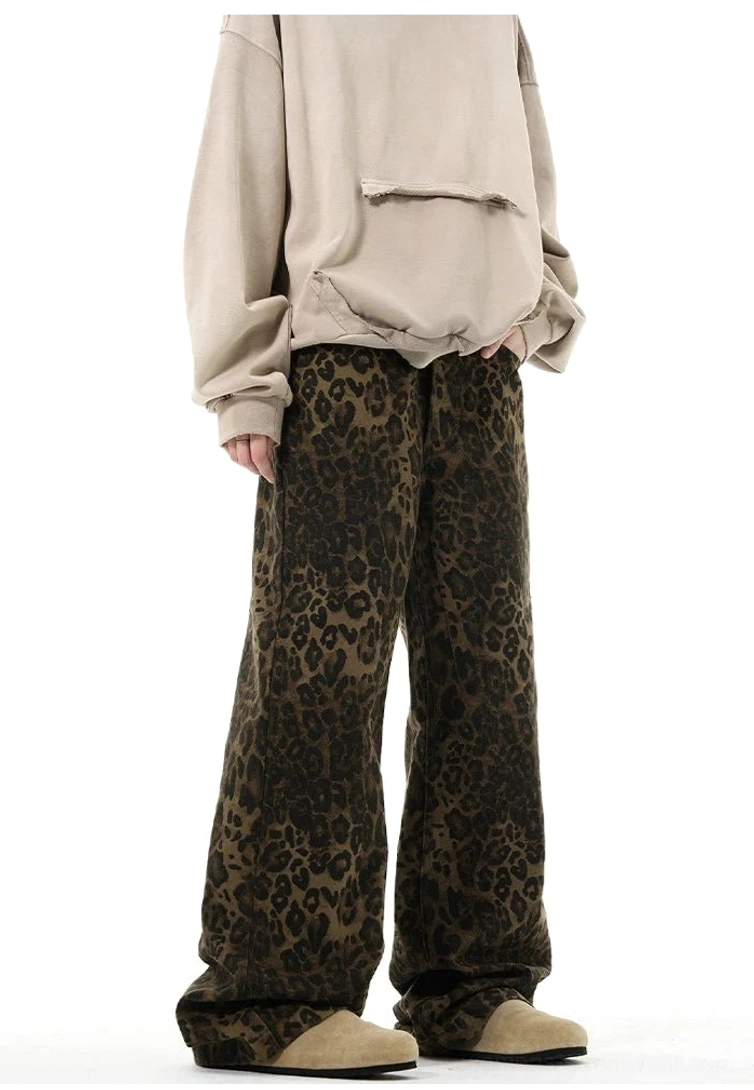 Leopard print relaxed wide-leg trousers styled with beige oversized hoodie and suede loafers in studio
