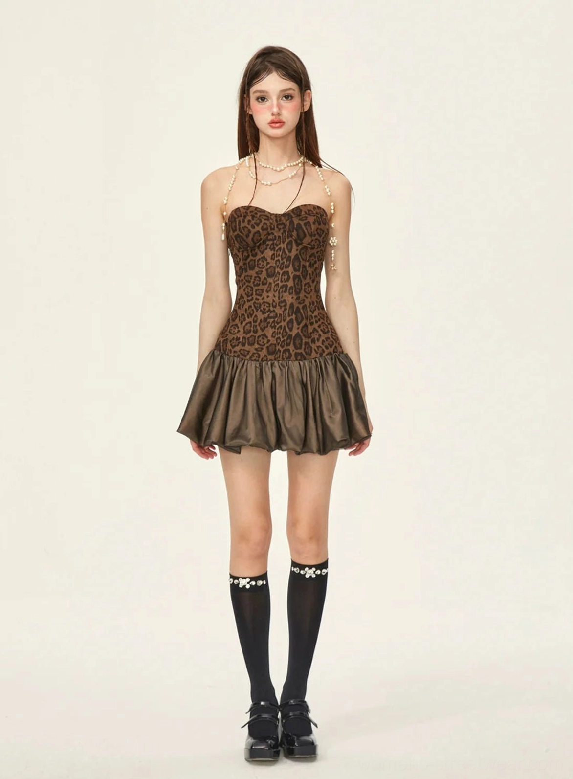 Front view of leopard print sweetheart mini dress with rhinestone knee-high socks black loafers and satin ruffled hem