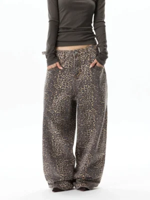 Front view of brown and charcoal leopard print wide-leg baggy jeans styled with a fitted dark brown top for Y2K streetwear