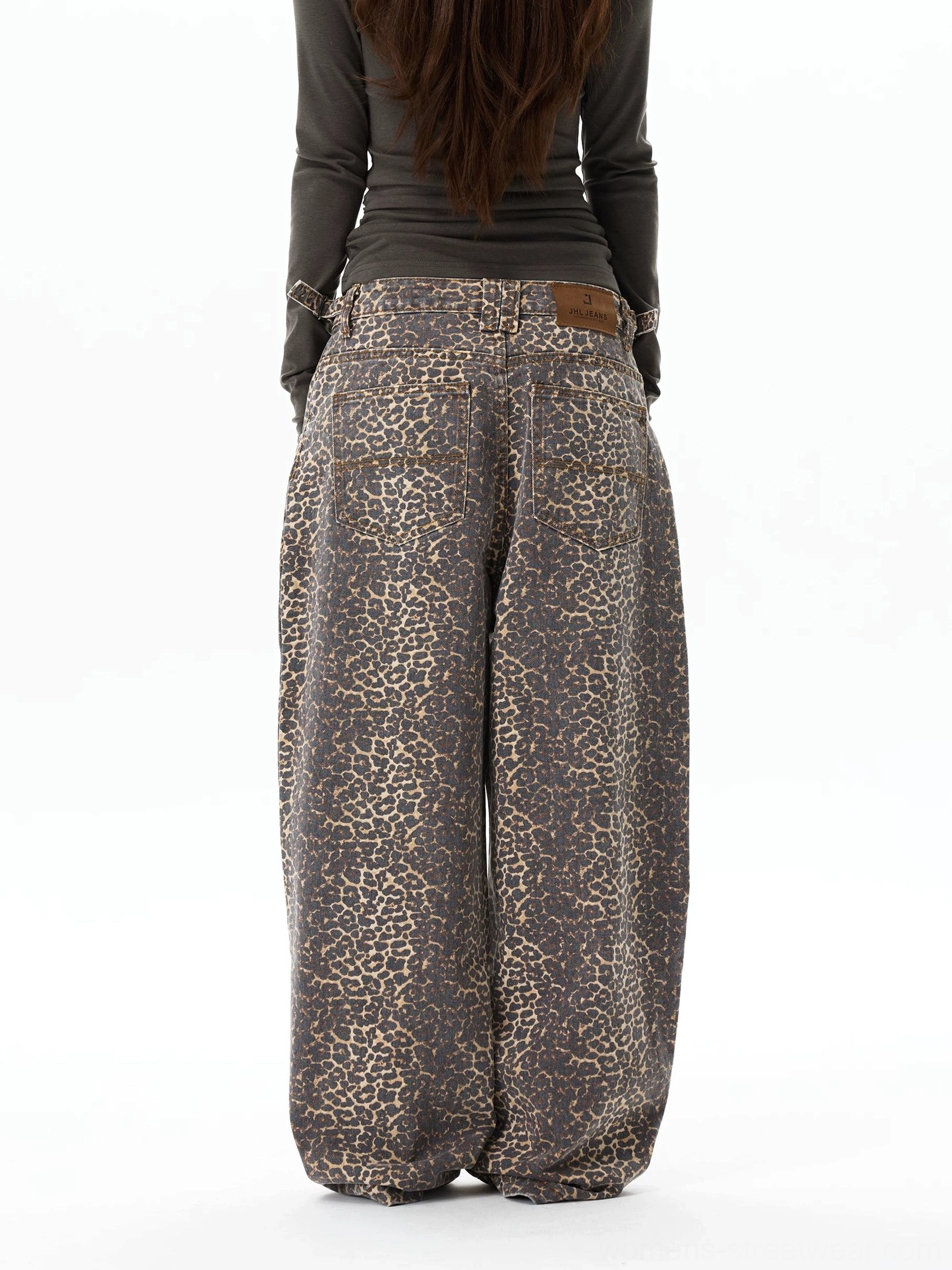 Rear view of leopard print wide-leg jeans showing back pockets, rear waistband patch, and oversized Y2K streetwear silhouette