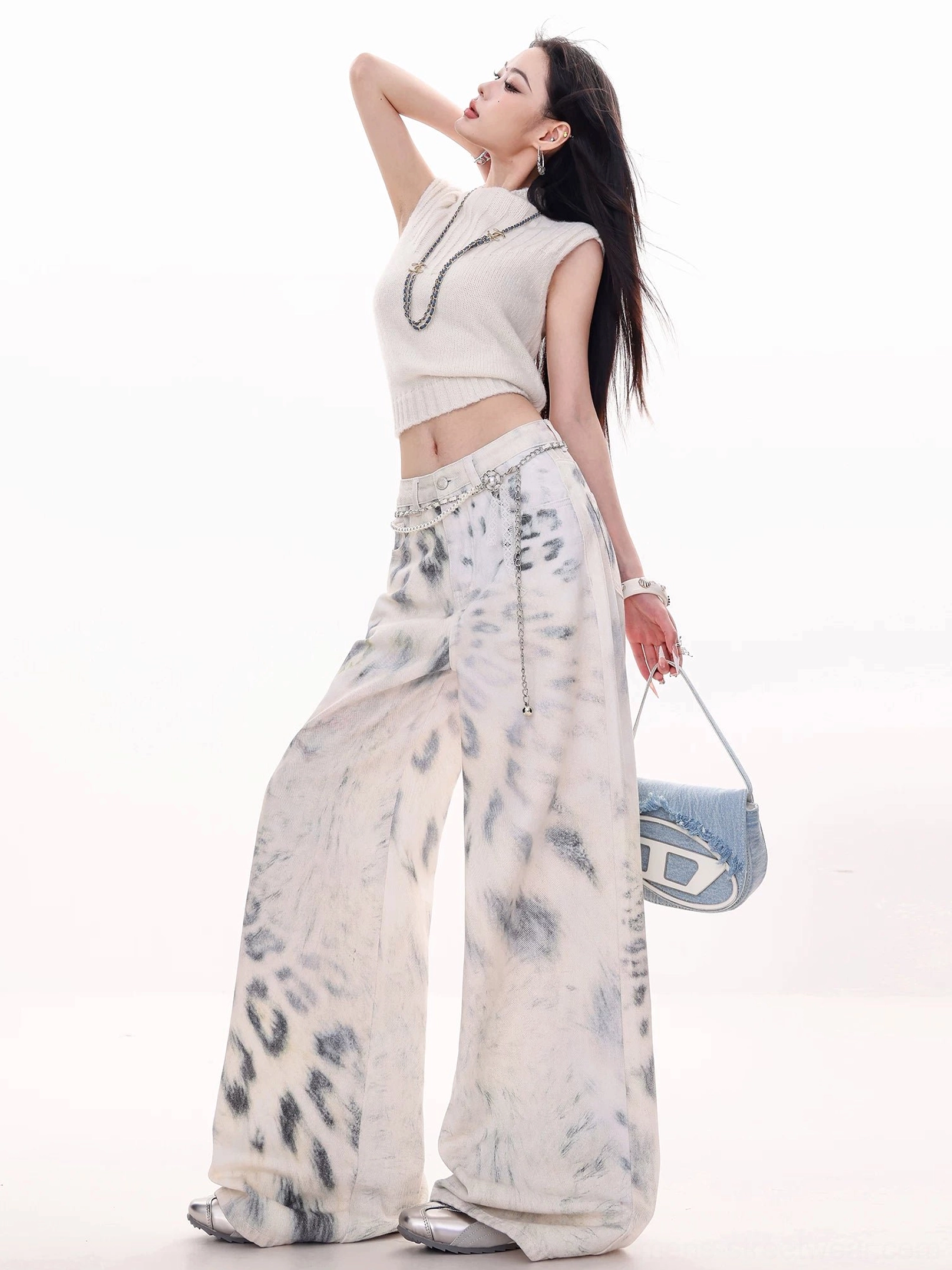 Three-quarter view of high-waisted leopard tie-dye wide-leg jeans highlighting the natural waist and elongated relaxed silhouette