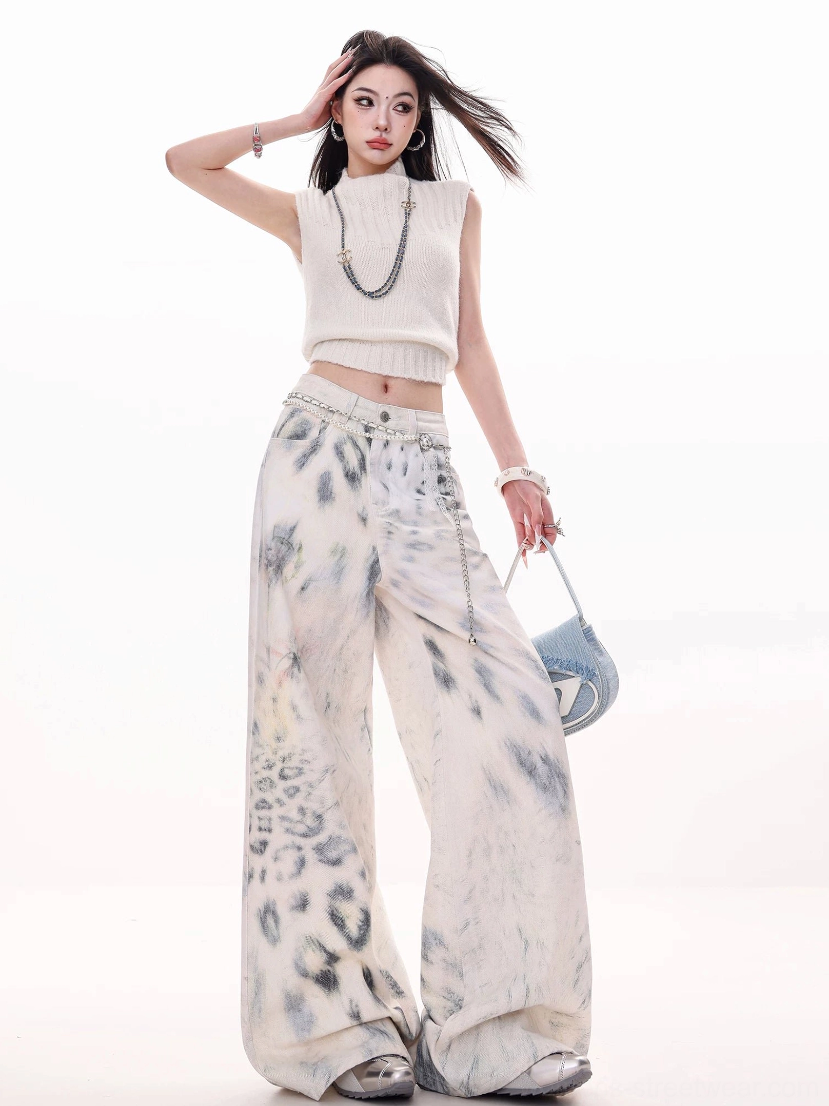 Side view of full-length leopard tie-dye wide-leg jeans showing the abstract animal print across the loose flowing pant legs