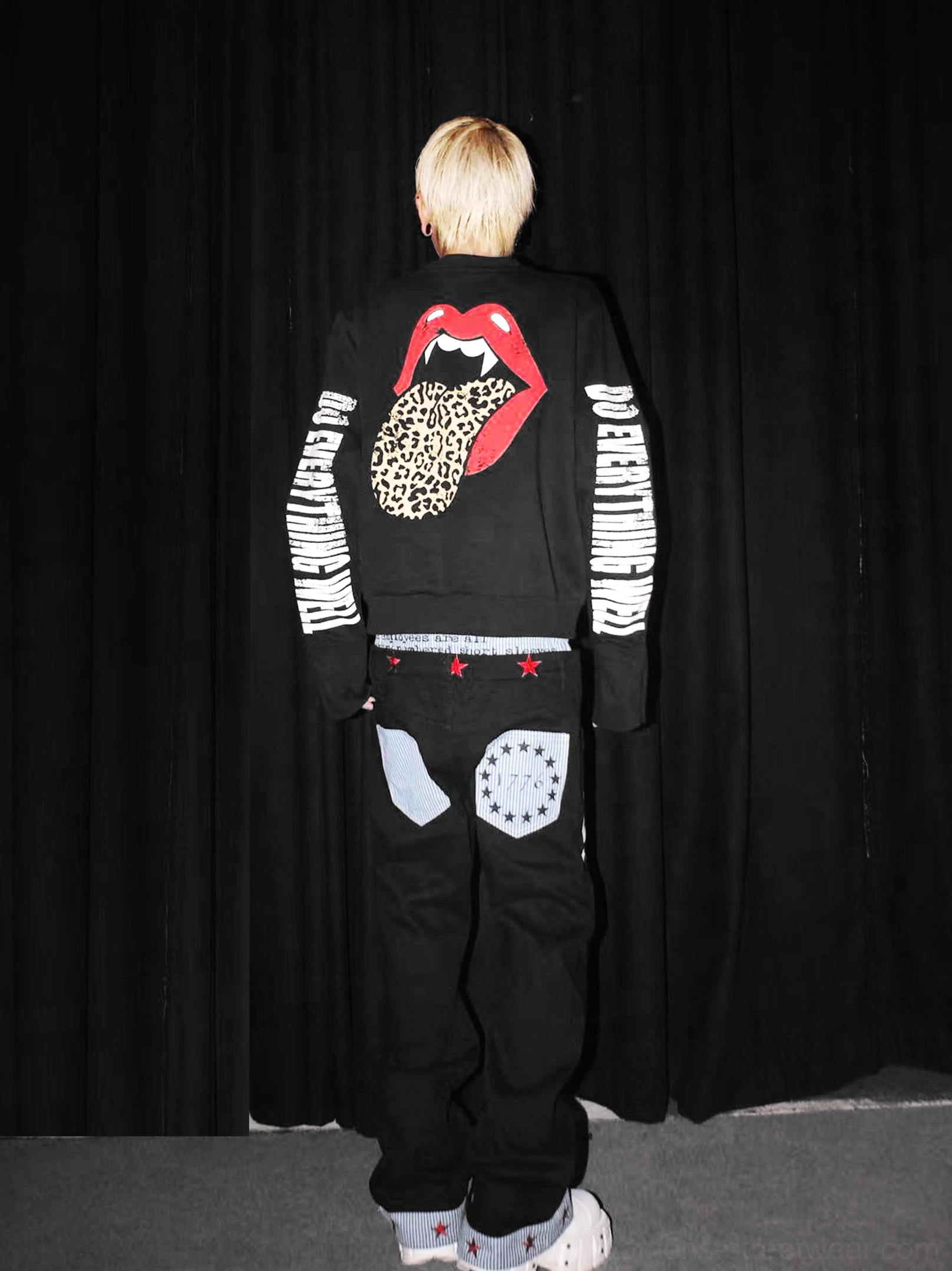 Full rear view of black fanged lips leopard tongue sweatshirt styled with matching streetwear sweatpants