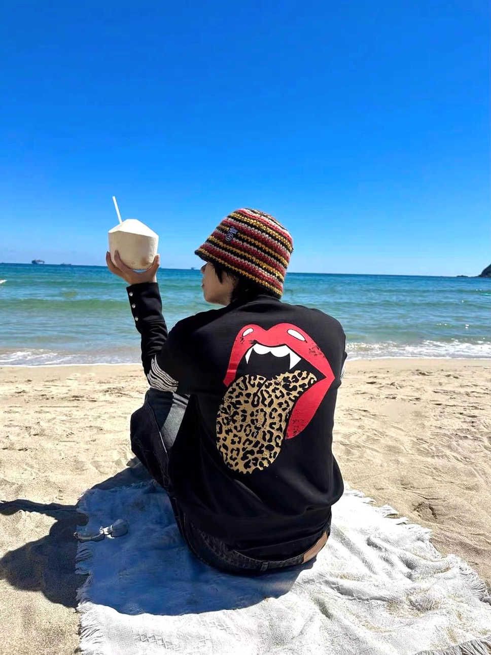 Back view of black streetwear sweatshirt featuring oversized red fanged lips and leopard tongue graphic