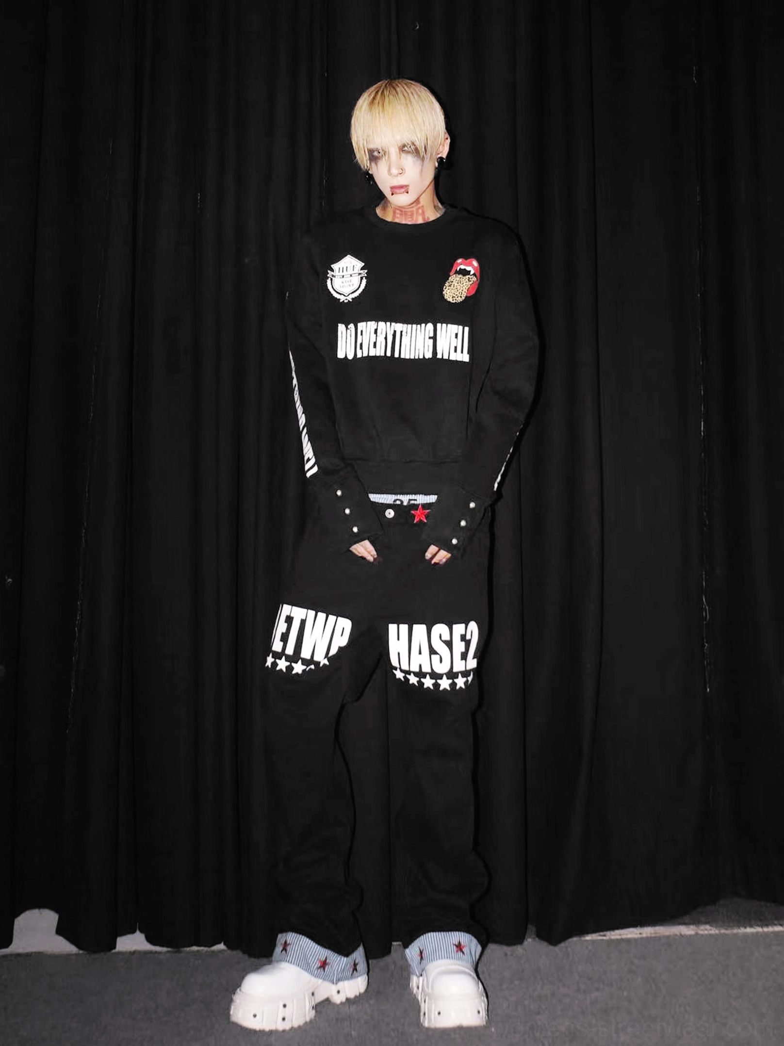 Full front view of black leopard tongue graphic streetwear sweatshirt styled with matching printed sweatpants