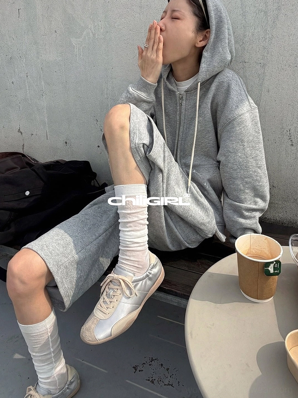 Light beige lace-up retro trainers styled with a grey hoodie loungewear set and sheer socks for an effortless casual cafe outfit
