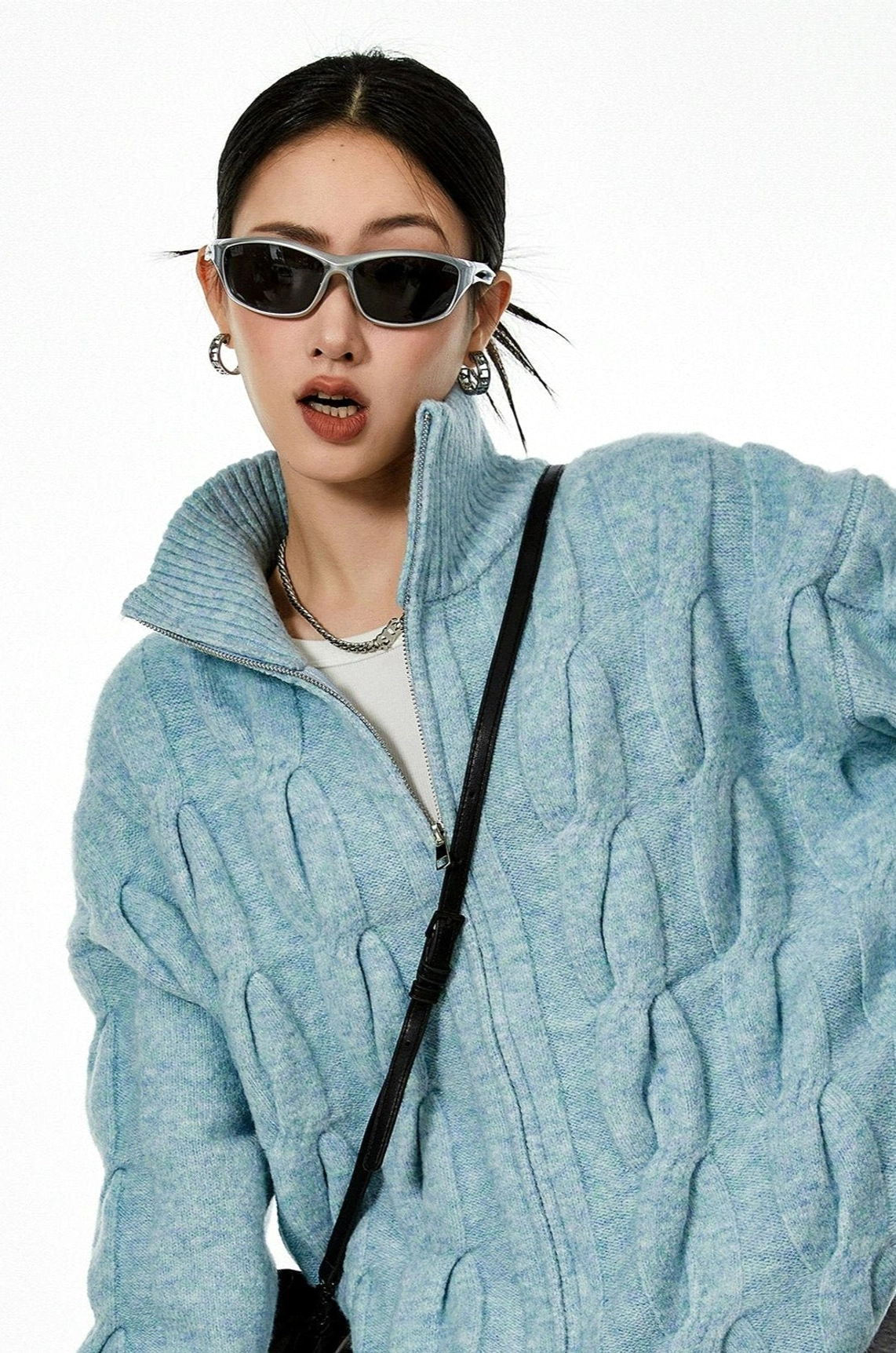 Light blue cable knit cardigan close up front detail twisted knit texture zipper placket