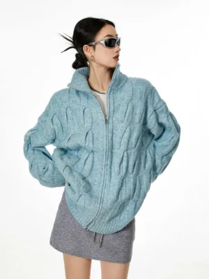 Light blue cable knit zip-up cardigan three quarter side profile dropped shoulders relaxed fit