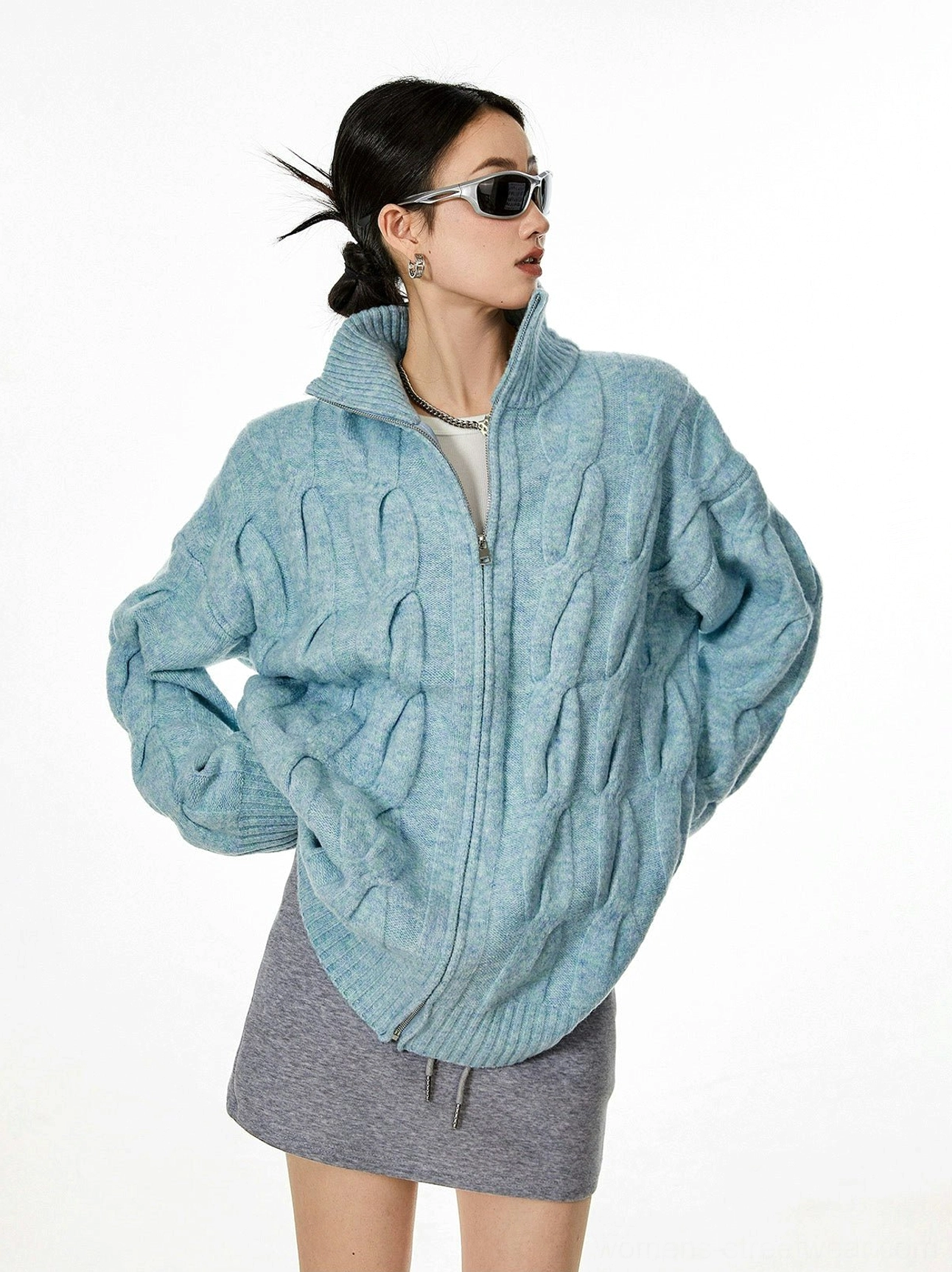 Light blue cable knit zip-up cardigan three quarter side profile dropped shoulders relaxed fit
