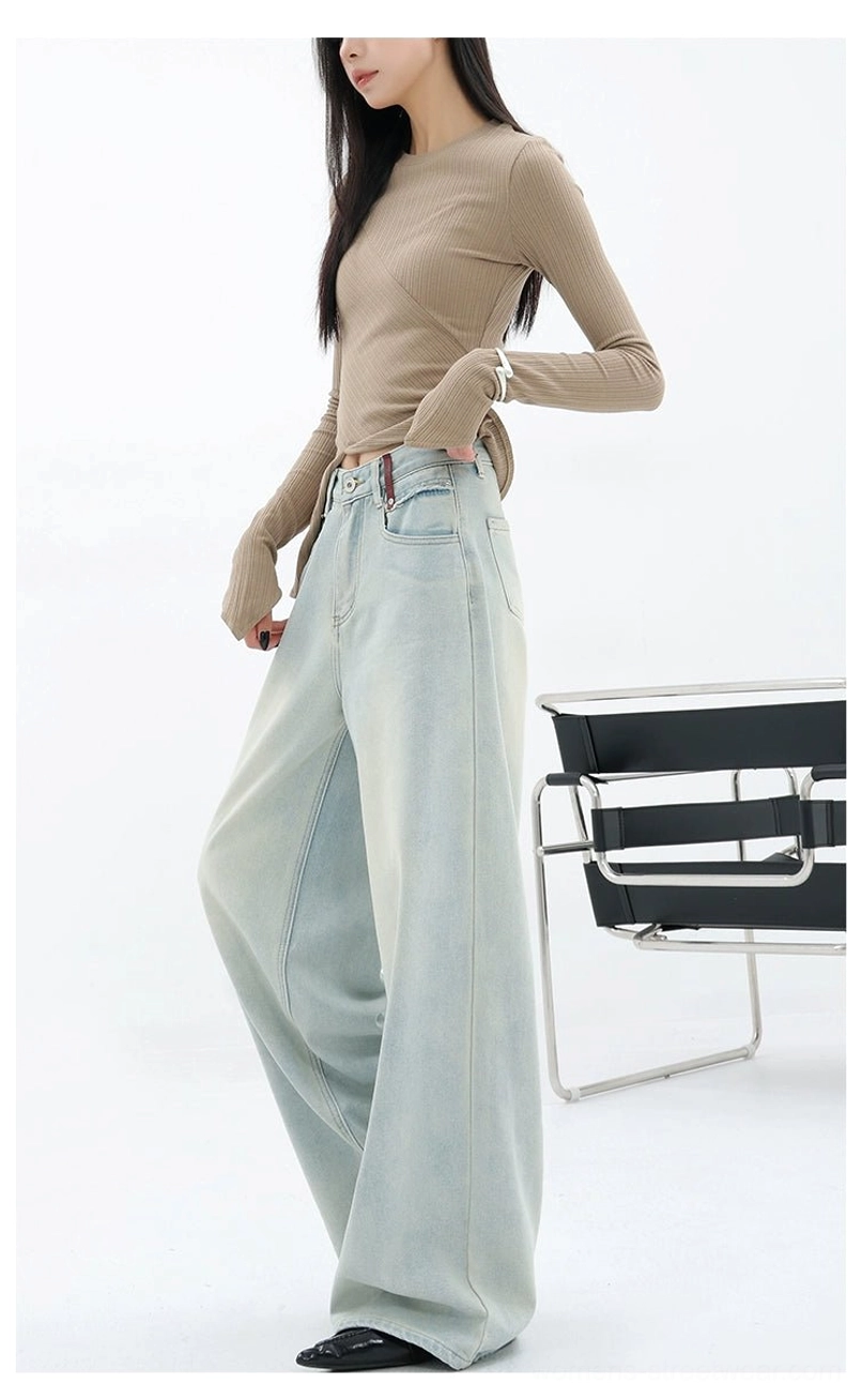 Light blue faded denim streetwear pants with full-length wide legs and artistic back-pocket embroidery