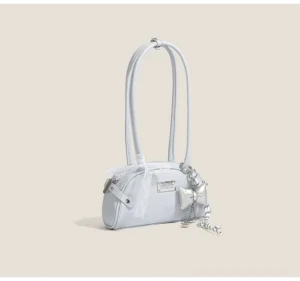 Light blue frosted lace bow half-moon shoulder bag with silver chain tassel charm on gray studio background