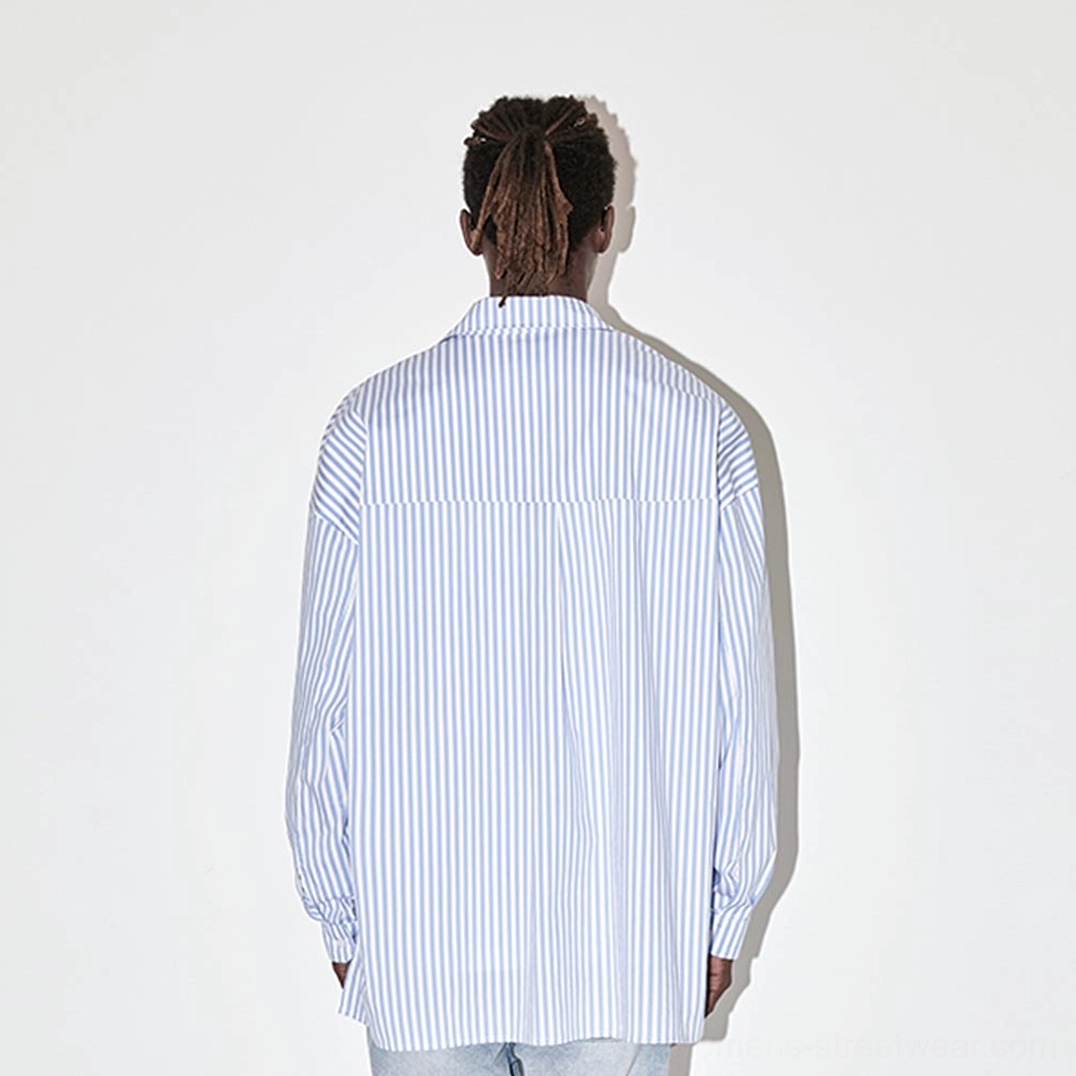 Back view of light blue geometric panel striped oversized streetwear shirt worn by male model