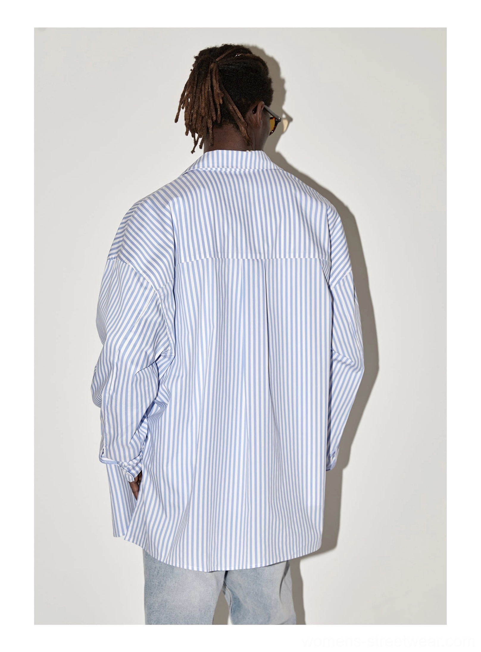 Three-quarter back view of light blue geometric panel striped oversized shirt with relaxed dropped shoulder fit