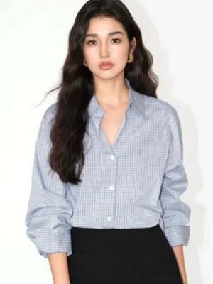 Light blue gingham relaxed oversized cotton blend button-up shirt front view styled with black mini skirt