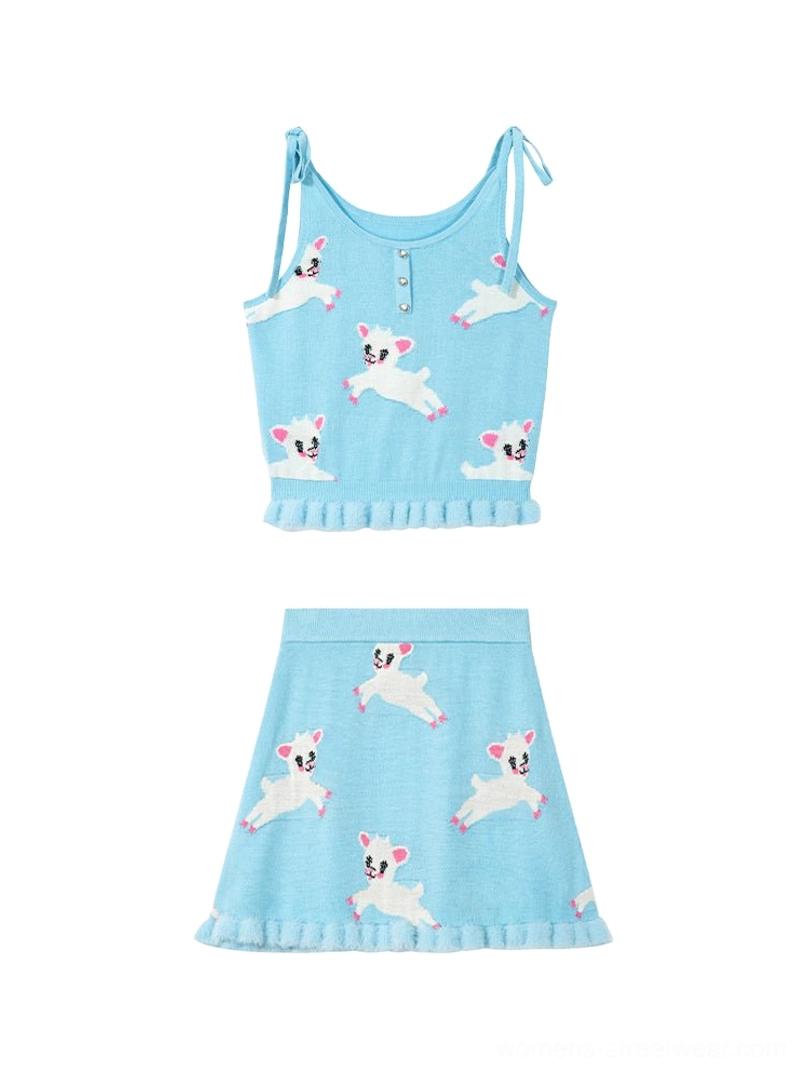 Flat lay display of complete light blue lamb print knit cami and A-line ruffle mini skirt two-piece set