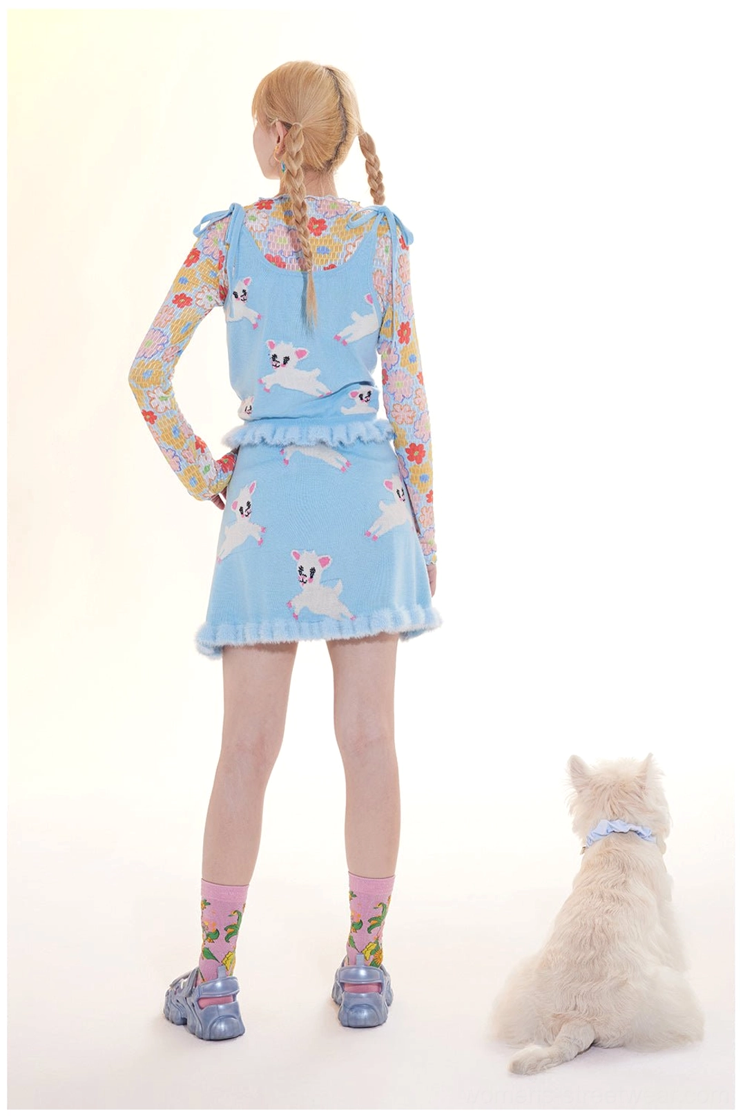 Back view of light blue lamb print knit two-piece outfit showing tailored waist and A-line mini skirt silhouette