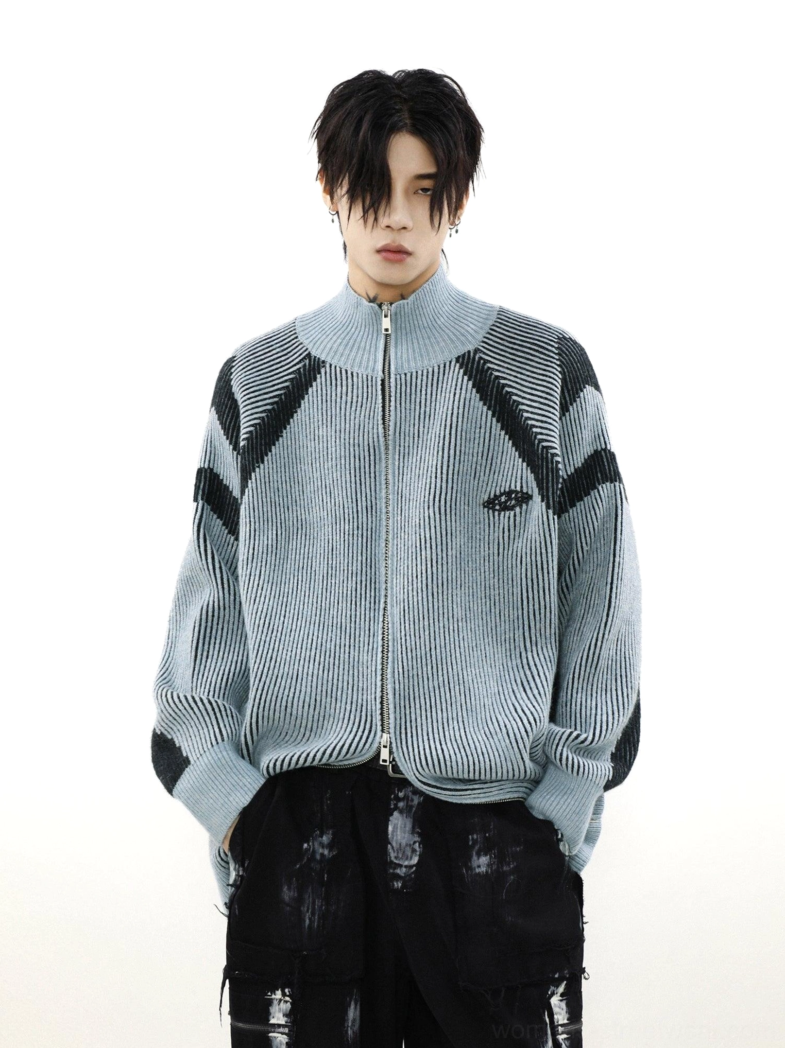 Light blue oversized high-neck knit cardigan with black contrast stripes, ribbed texture, and small chest logo detail