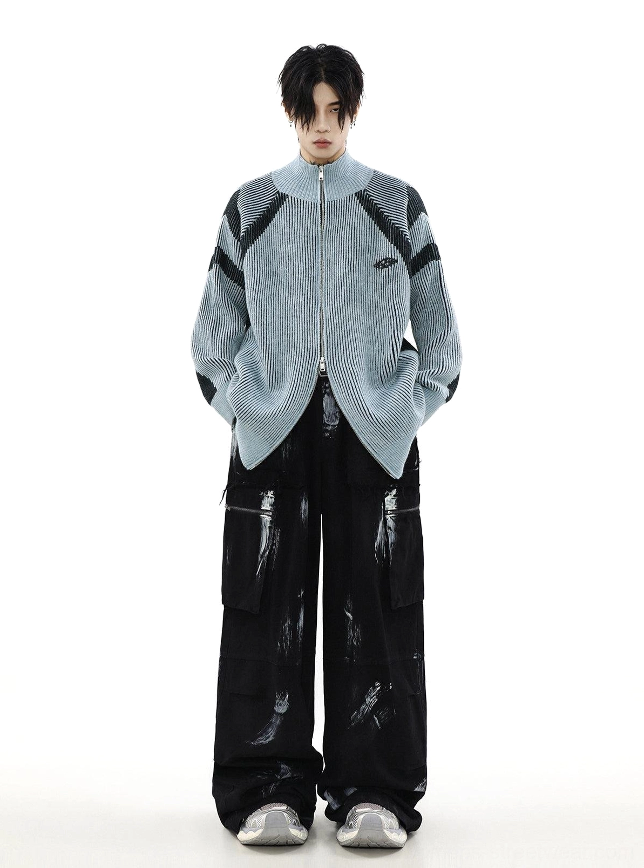 Light blue oversized ribbed cardigan with black shoulder stripes, full zipper, and relaxed wide-leg streetwear outfit