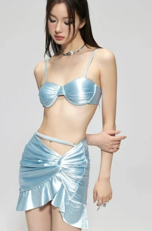Light blue satin bralette and ruffle mini skirt set three quarter view with low rise waist cut out