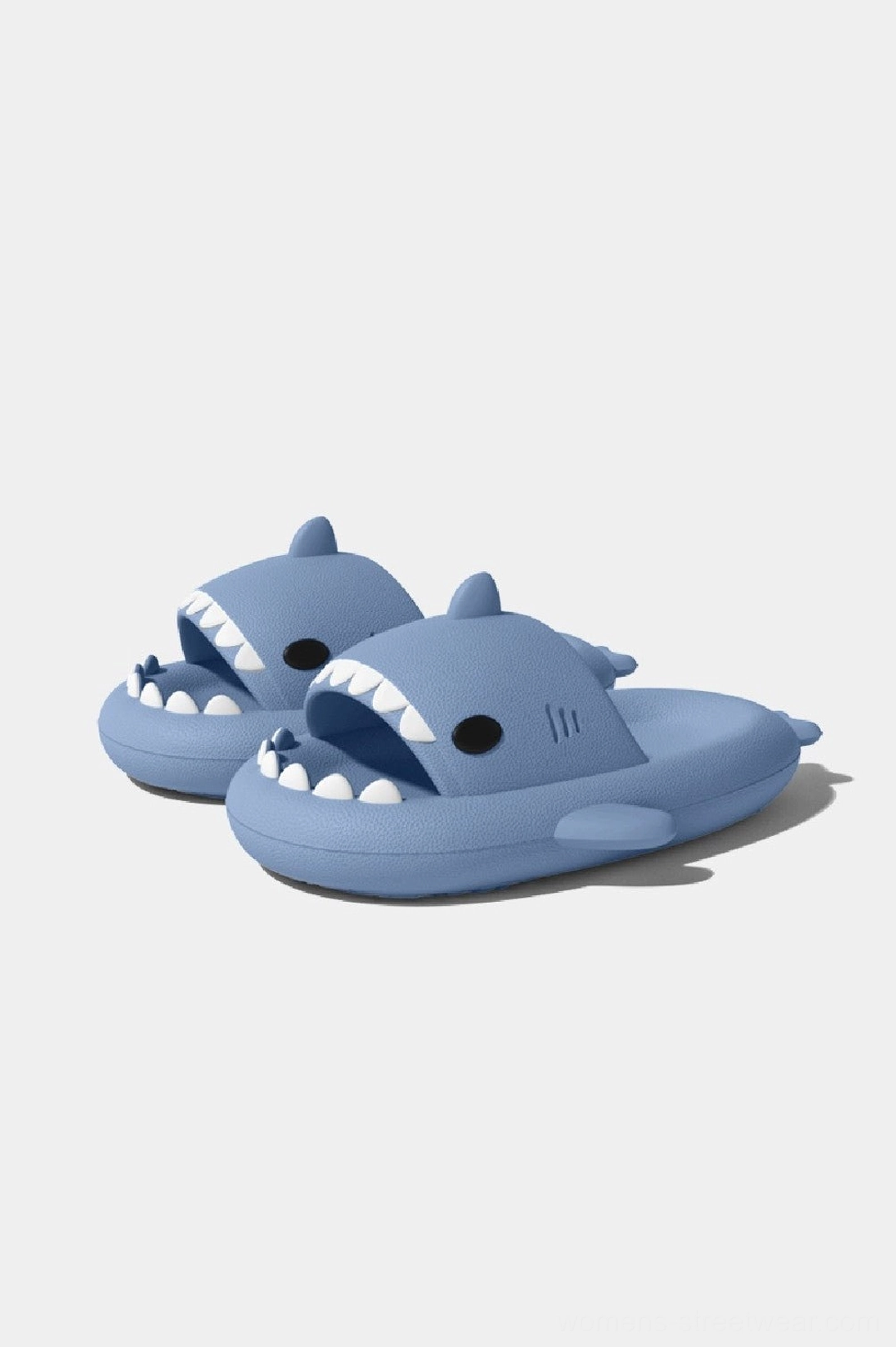 Light blue shark slide slippers with cute cartoon shark styling, open-toe silhouette, and thick cushioned comfort sole