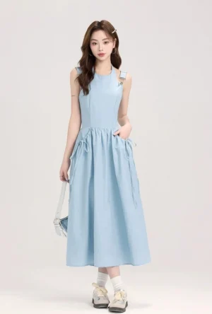 Light blue sleeveless overall midi dress full front view featuring ruched drawstring waist pockets