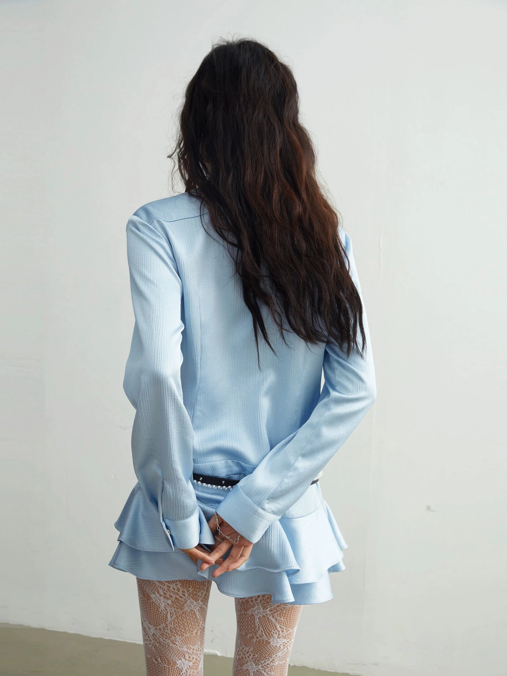 Light blue utility ruffle mini dress product image showing the zip-front silhouette, structured collar, pockets, tiered skirt, and contemporary streetwear design