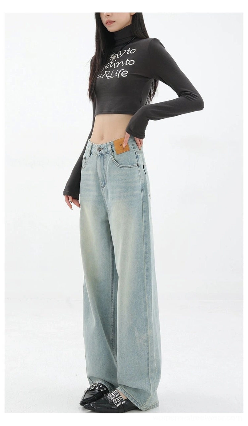 Light blue washed high-waisted wide-leg jeans styled with a black cropped printed top and platform shoes for a Y2K Korean streetwear look