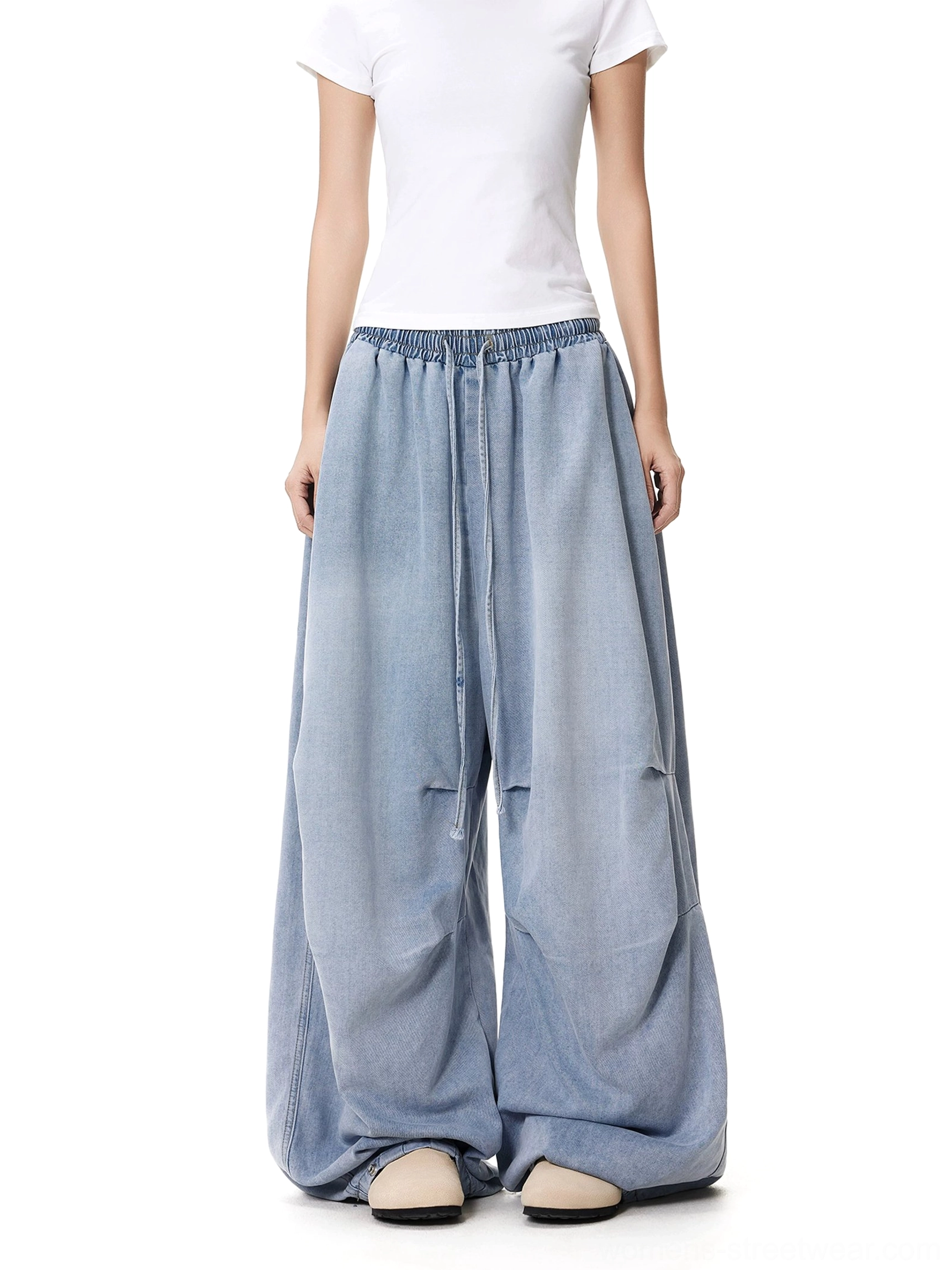 Full front view of light blue women's wide-leg jeans with a vintage washed finish, relaxed oversized fit, and clean button-adjustable hems
