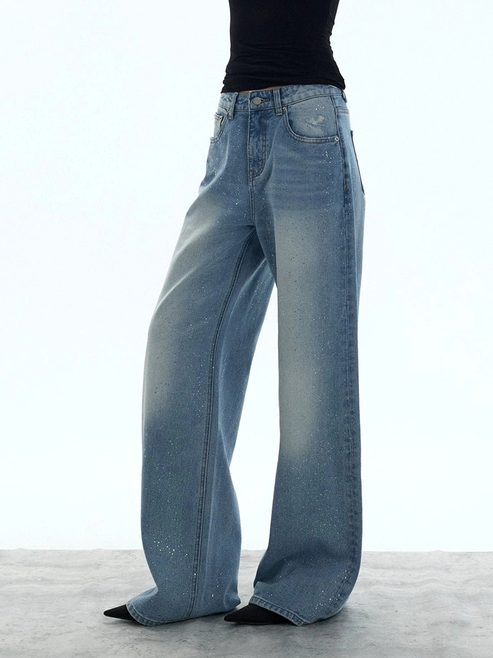 Side view of light blue washed wide-leg denim jeans with a loose silhouette and relaxed everyday styling